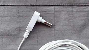 close up image of gray earthing bedsheet with white grounding cord