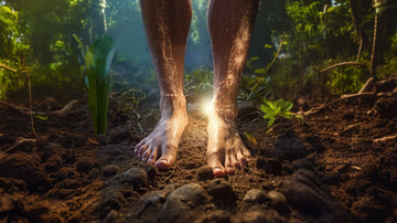 A man grounding with both bare feet on the ground and receiving bioelectrical earthing benefits