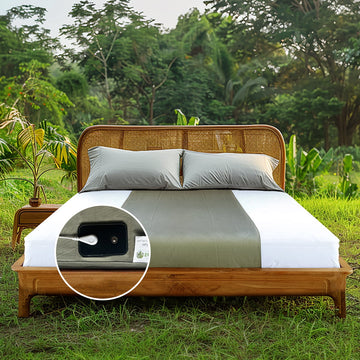 Earthy green grounding flat half-sheets laid out on a wooden bed in a natural setting, focusing on tension relief and metabolic health benefits