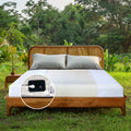 Natural-colored grounding flat half-sheets displayed on a wooden bed outdoors, demonstrating their role in reducing inflammation and boosting circulation