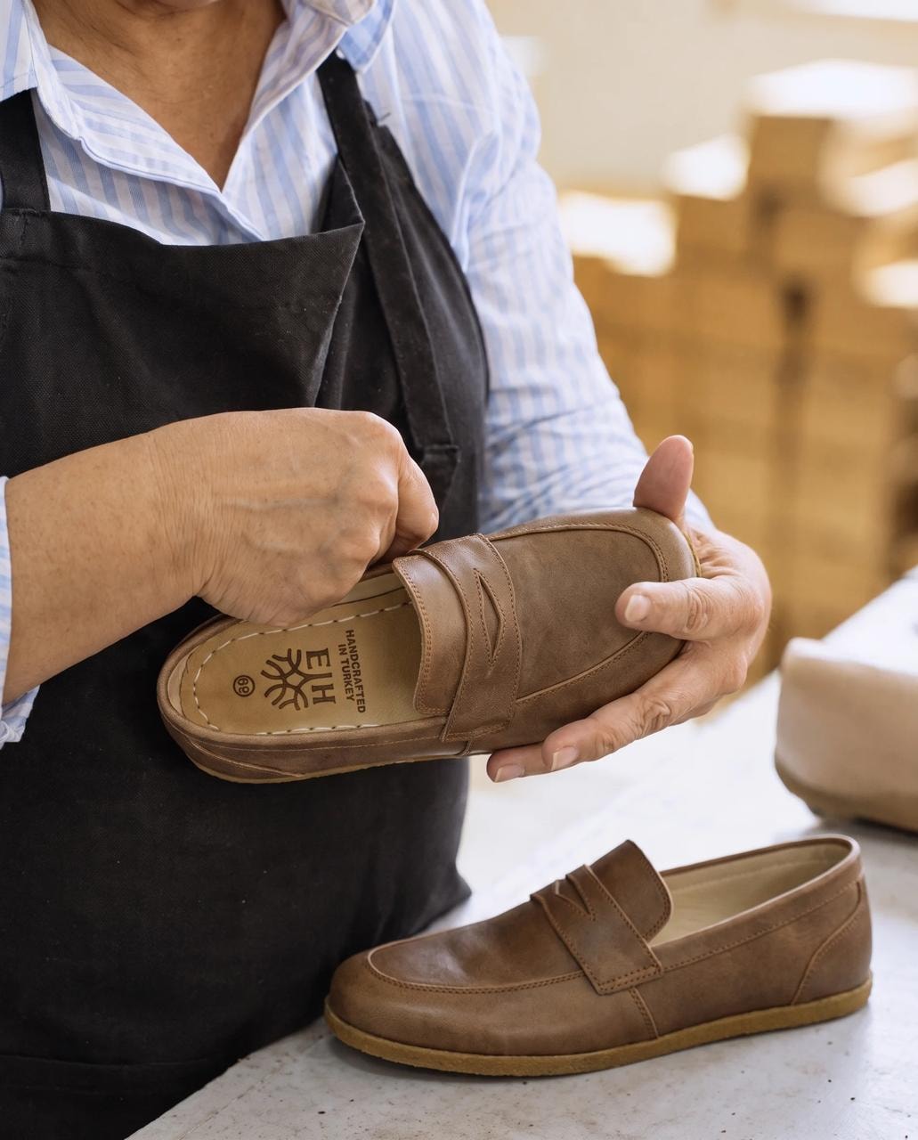 Artisan finishing a leather grounding loafer at the workshop